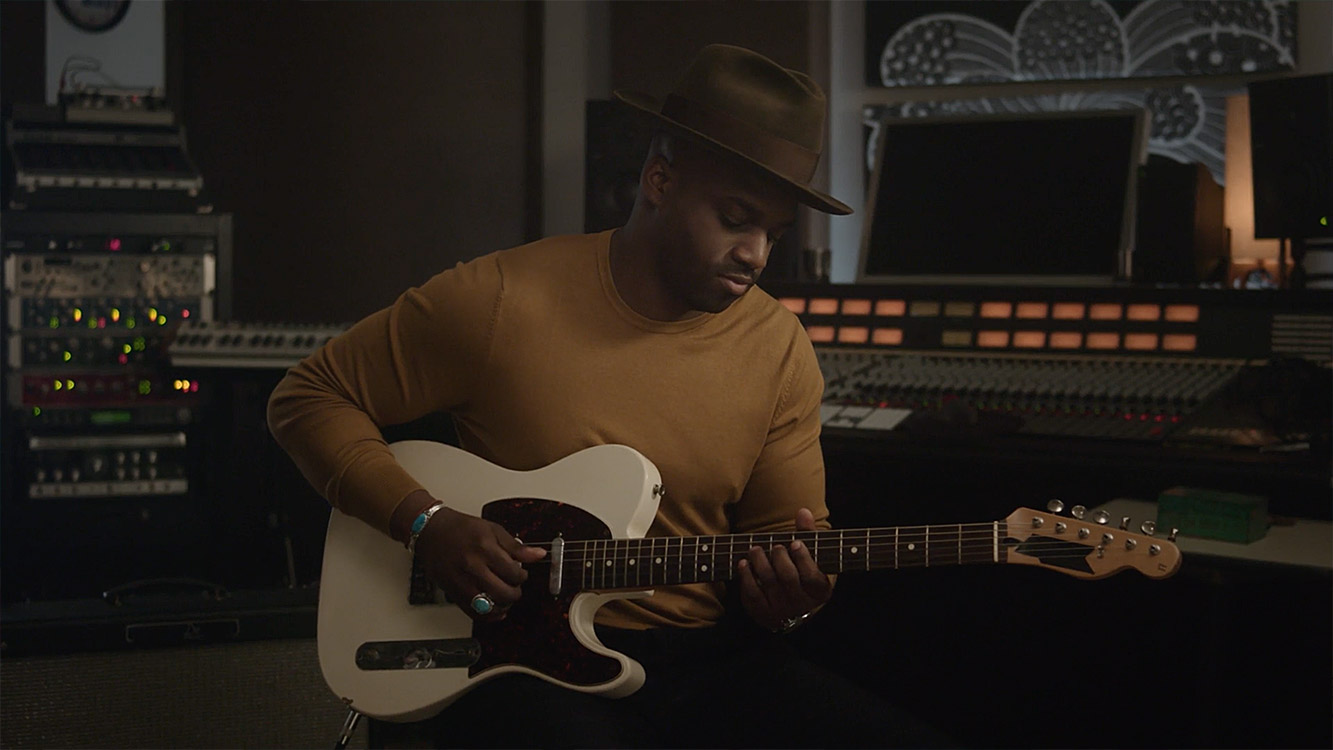 Man playing electric guitar in studio